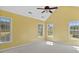 Spacious bedroom with a vaulted ceiling, carpet, and lots of natural light from multiple windows at 80 Greta Ln, Henderson, NC 27537