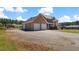 Large brick home with three-car garage and extensive driveway at 80 Greta Ln, Henderson, NC 27537