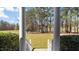 View from front porch steps looking out at wooded property at 80 Greta Ln, Henderson, NC 27537