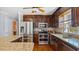 Beautiful kitchen with stainless steel appliances, double oven, granite countertops, and wooden cabinets at 80 Greta Ln, Henderson, NC 27537