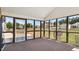 Enclosed sunroom with wood floor and views of the backyard at 80 Greta Ln, Henderson, NC 27537