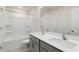 Bathroom featuring a double sink vanity with modern fixtures and white tiled shower with tub at 816 Canis Minor Rd, Wendell, NC 27591