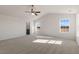 Vaulted ceiling bedroom featuring carpeted floors, ceiling fan and bright natural light from large windows at 816 Canis Minor Rd, Wendell, NC 27591