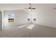 Vaulted ceiling bedroom featuring carpeted floors, ceiling fan and bright natural light from large windows at 816 Canis Minor Rd, Wendell, NC 27591