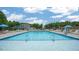 Expansive community pool area with plenty of seating, umbrellas, and space to enjoy the outdoors at 816 Canis Minor Rd, Wendell, NC 27591