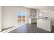 Bright kitchen featuring stainless steel appliances, granite countertops, white cabinets, and sliding glass doors to outdoor patio at 816 Canis Minor Rd, Wendell, NC 27591