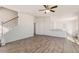 Spacious living room featuring hardwood floors, staircase, and modern finishes, with an open layout to the kitchen at 816 Canis Minor Rd, Wendell, NC 27591