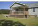 Relaxing back porch with a view of the expansive lawn, ceiling fan, and ample space at 860 Bear Rd, Benson, NC 27504