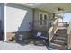 Charming back porch with a seating area, brick foundation, and well-maintained landscaping at 860 Bear Rd, Benson, NC 27504