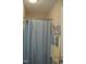 Simple bathroom featuring a shower with blue curtain and clean, functional space at 860 Bear Rd, Benson, NC 27504