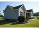 Charming side view of a gray home with black shutters and well-maintained landscaping at 860 Bear Rd, Benson, NC 27504