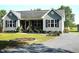 Well-maintained home featuring tidy landscaping, complemented by a gravel driveway at 860 Bear Rd, Benson, NC 27504