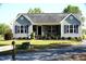 Charming single-story home with gray siding, black shutters, and a well-manicured lawn at 860 Bear Rd, Benson, NC 27504