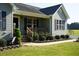 Well-maintained home with tidy landscaping, complemented by a paved walkway to the front door at 860 Bear Rd, Benson, NC 27504