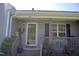 Inviting front entrance with covered porch, decorative wreath, and well-maintained landscaping at 860 Bear Rd, Benson, NC 27504