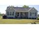 Inviting home with gray siding, black shutters, and a charming front porch at 860 Bear Rd, Benson, NC 27504