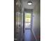 Hallway with hardwood floors leading to an outdoor view and bright natural light at 860 Bear Rd, Benson, NC 27504