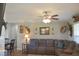 Comfortable living room featuring a ceiling fan, mounted wildlife decor, and plush sofa at 860 Bear Rd, Benson, NC 27504