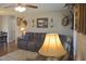 Inviting living room featuring a plush sofa, wildlife decor, and comfortable lighting at 860 Bear Rd, Benson, NC 27504