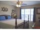 Comfortable bedroom with a large window, a ceiling fan, and neutral-toned decor at 860 Bear Rd, Benson, NC 27504