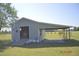 Open garage door view of the outbuilding and the covered area at 860 Bear Rd, Benson, NC 27504