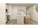 Bright kitchen with a large island, modern appliances, and bar stool seating at 879 Pilot St, Haw River, NC 27258