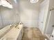 Bathroom boasts a double vanity, tiled flooring, and shower-tub at 10 Cricket Hollow Run, Clayton, NC 27520