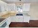 Clean kitchen featuring white cabinets, sleek countertops, and stainless steel sink at 10 Cricket Hollow Run, Clayton, NC 27520