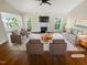 Bright and inviting living room with fireplace, ample seating, and large windows at 10 Cricket Hollow Run, Clayton, NC 27520