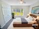 Cozy main bedroom featuring a plush rug, large window, and ample closet space at 10 Cricket Hollow Run, Clayton, NC 27520