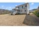 View of a spacious backyard and home, featuring a screened porch and a well-maintained lawn at 10119 Second Star Ct, Raleigh, NC 27613