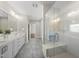 Modern bathroom featuring a glass shower, double vanity, and tile flooring at 10119 Second Star Ct, Raleigh, NC 27613