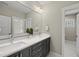 Bathroom features a double sink vanity, with quartz countertop and stainless fixtures at 10119 Second Star Ct, Raleigh, NC 27613