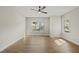 Bedroom with hardwood floors, two windows, and ceiling fan provides ample natural light at 10119 Second Star Ct, Raleigh, NC 27613