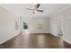Spacious bedroom with hardwood floors, two windows and a ceiling fan at 10119 Second Star Ct, Raleigh, NC 27613