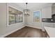Dining area with windows, modern lighting, and wood floors at 10119 Second Star Ct, Raleigh, NC 27613