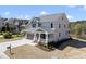 Charming two-story home featuring a covered porch, attached garage, and manicured landscaping at 10119 Second Star Ct, Raleigh, NC 27613