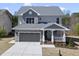 Beautiful home with gray siding, stone accents, a covered porch, and an attached garage at 10119 Second Star Ct, Raleigh, NC 27613