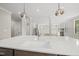 Close-up of kitchen island with sink and quartz countertop, open to living area at 10119 Second Star Ct, Raleigh, NC 27613