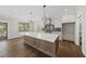 Bright, open kitchen featuring a large island, stainless steel appliances, and modern pendant lighting at 10119 Second Star Ct, Raleigh, NC 27613