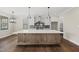 Well-lit kitchen showcasing a large central island and gray backsplash at 10119 Second Star Ct, Raleigh, NC 27613