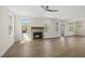 Open-concept living room features a fireplace, wood floors, and natural light from multiple windows at 10119 Second Star Ct, Raleigh, NC 27613