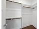 Modern walk-in closet features built-in shelving and wood floors at 10119 Second Star Ct, Raleigh, NC 27613