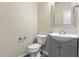 Powder room featuring modern vanity, sink, and toilet at 1019 Thoughtful Spot Ln, Durham, NC 27703