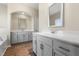Bathroom with dual sinks, wood floors, and a large mirror at 1019 Thoughtful Spot Ln, Durham, NC 27703