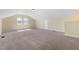A large bonus room offers ample space, lots of light, plush carpet, and neutral walls at 1019 Thoughtful Spot Ln, Durham, NC 27703