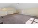 This is a large bonus room with neutral walls and plush carpet at 1019 Thoughtful Spot Ln, Durham, NC 27703