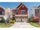 Charming red two-story home with a two-car garage and well-maintained front yard at 1019 Thoughtful Spot Ln, Durham, NC 27703