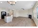 Open-concept living room and kitchen with a fireplace, modern island, and abundant natural light at 1019 Thoughtful Spot Ln, Durham, NC 27703