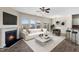 Bright living room with a fireplace, modern furnishings, and ample natural light from large windows at 1019 Thoughtful Spot Ln, Durham, NC 27703